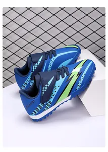 Detailed view of blue children's TF soccer shoes with velcro and lightning pattern