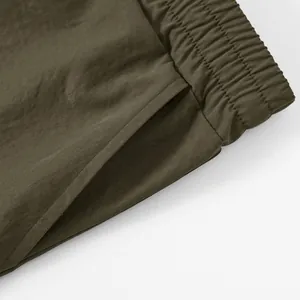 Detailed close-up showing the sturdy pocket construction and elastic waistband of men's cargo shorts.