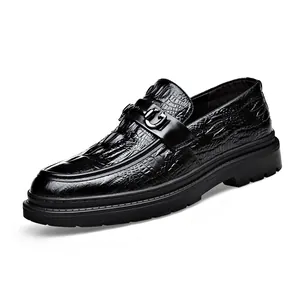 Men's black crocodile pattern leather loafers with metal buckle on white background