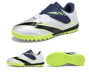 Detailed view of kids' TF soccer cleats with Velcro straps and lime green turf studs