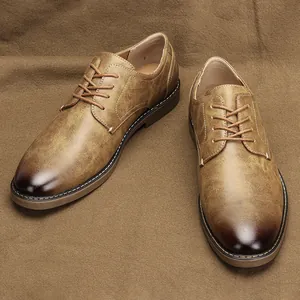 Detail of retro brown men's oxford shoes with burnished toe and lace-up design
