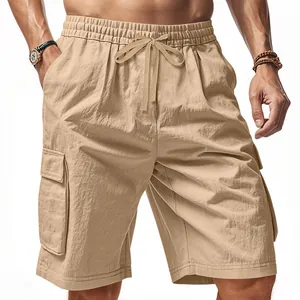 Detail view of khaki tactical cargo shorts with large side pockets and drawstring waist