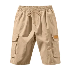 Khaki men's loose cargo shorts featuring drawstring waist and tactical pockets