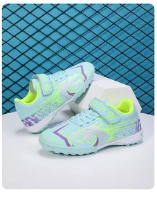 Détail de chaussures de football bleu pour enfants avec scratch et motif de dragon.