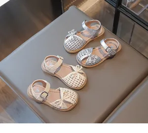 Silver and cream woven sandals for girls featuring cute bows and breathable closed-toe design