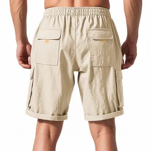 Detailed back view of khaki tactical cargo shorts featuring elastic waist and large flap pockets