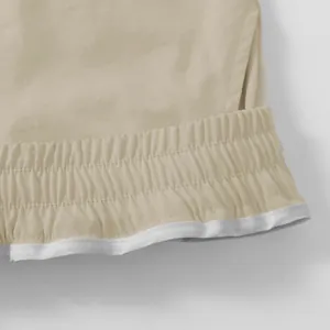 Close-up of elastic waistband on American cargo shorts with durable fabric texture.