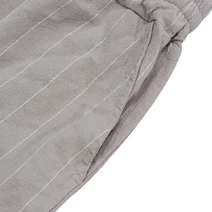 Close-up detail of side pocket and breathable striped linen fabric on men's shorts