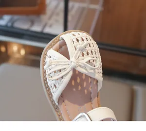 Detail view of children's woven breathable closed-toe sandals for girls with bow