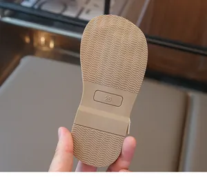 Detail of non-slip rubber sole on children's woven sandals featuring size 26 marking