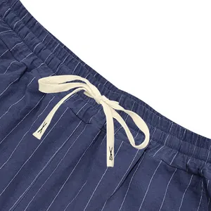 Close-up detail of men's blue vertical striped shorts with white elastic drawstring waistband