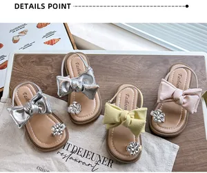 Detailed view of girls' bow-knot sandals with rhinestone accents in multiple colors