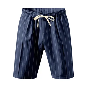 Close-up detail of navy blue vertical striped beach shorts with cream drawstring
