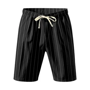Detailed view of men's black vertical pinstripe shorts featuring a cream drawstring waist tie