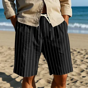Lifestyle detail of men's black vertical striped linen beach shorts with drawstring