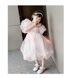 Elegant girls' white sandals with sparkling rhinestones and delicate bow details.