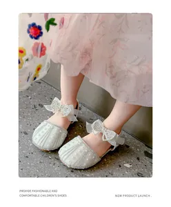 Elegant girls' rhinestone bow princess sandals worn by a child for summer fashion.