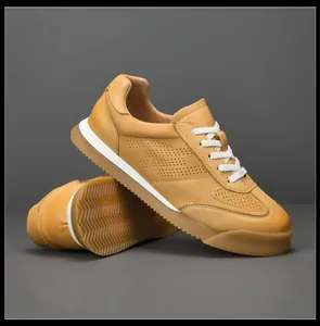 Detailed view of men's mustard yellow leather GAT sneakers with perforated panels.