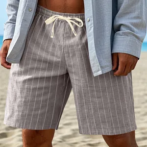 Detail of men's grey vertical striped linen shorts with drawstring for beachwear.