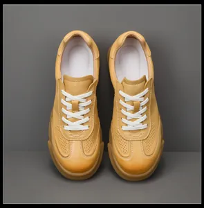 Top view of men's yellow genuine leather sneakers with breathable perforated details