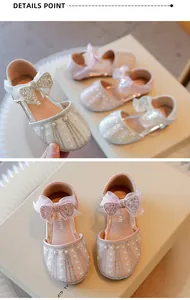 Close-up of girls' princess shoes featuring elegant rhinestones, pearls, and a bowknot.