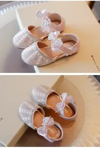 Detailed view of pink princess shoes for girls with rhinestones, pearls and bows.