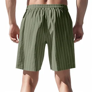 Detailed back view of olive green pinstriped linen shorts for men in a loose beach style