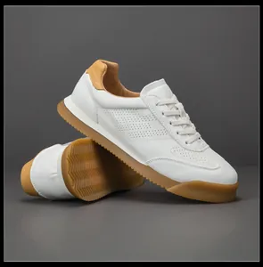 Detailed side view of white leather breathable men's GAT sneakers with gum sole
