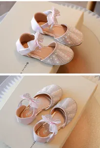 Detail of pink toddler girl princess shoes with rhinestone bow and soft sole