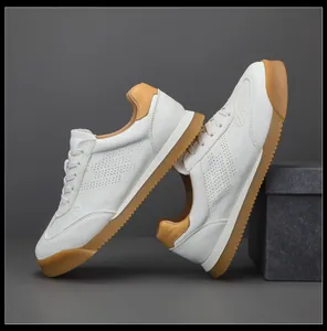 Detailed macro side view of premium white leather GAT sneakers with durable gum soles