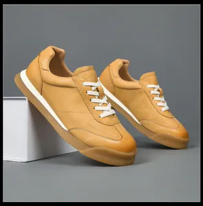 Detailed side view of tan leather German army trainers with gum rubber sole