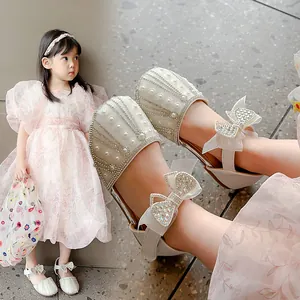 Elegant girls' white princess shoes with rhinestones, pearls and bow detail for summer events.