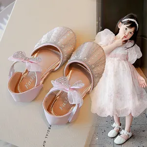 Pink princess shoes for girls decorated with sparkling rhinestones and silk bows