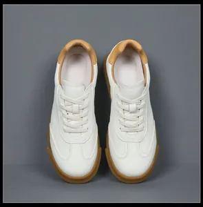 Top-down view of men's white leather German Army Trainers with gum soles