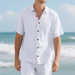 Close-up detail of a men's white linen-style short-sleeved casual shirt on a beach
