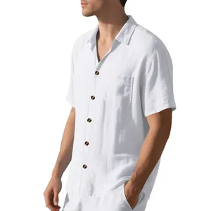 Close-up detail showing white linen-textured men's short sleeve shirt with contrast buttons