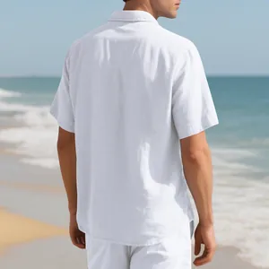 Back view of men's relaxed white short-sleeve linen shirt in a sunny beach setting