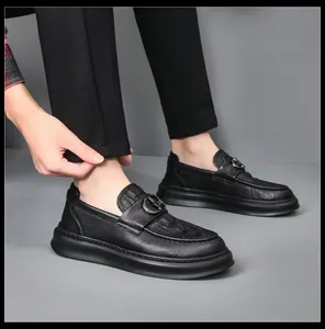 Professional close-up of stylish black leather men's loafers worn with formal trousers