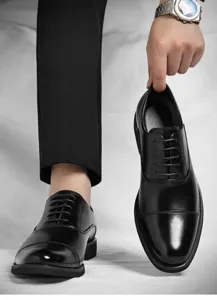 Detailed macro view of black polished leather oxford shoes for business formal wear