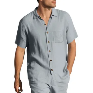 Detail view of a men's woven short-sleeve shirt in light blue with lapel collar.