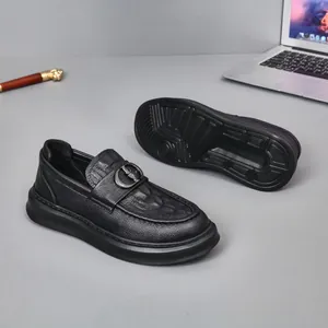 Stylish black leather men's slip-on loafers with textured upper and metal buckle