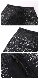 Detailed macro view of black denim jeans featuring sparkling rhinestone firework patterns