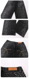 Detailed view of fireworks rhinestone pattern on black straight-leg denim jeans