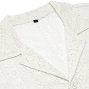 Close-up detail of men's white lace hollow-out short sleeve shirt lapel and fabric texture