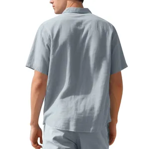 Back view of a casual men's light blue short sleeve woven shirt with clean texture