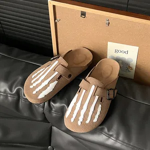 Women's brown suede platform mules featuring a unique white skeleton hand print