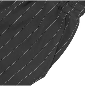 Close-up view of black striped shorts featuring elastic waist and side pocket details.