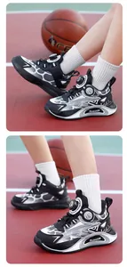 Detailed view of kids' sports shoes with rotary buckle on basketball court.