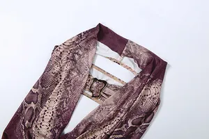 Detailansicht eines Neckholder-Jumpsuits mit Schlangenmuster, V-Ausschnitt und Schnalle