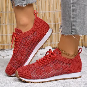 Detailed side view of red breathable mesh lace sneakers for women worn by a model
